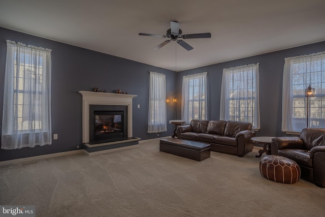 unfurnished living room featuring ceiling fan and carpet