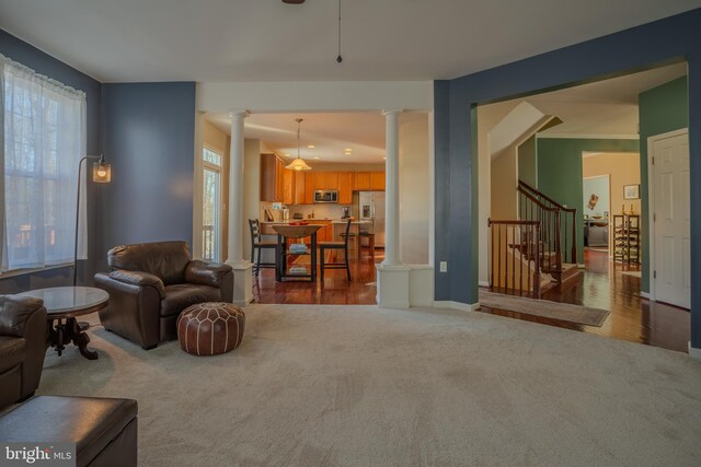 living room with ornate columns and carpet