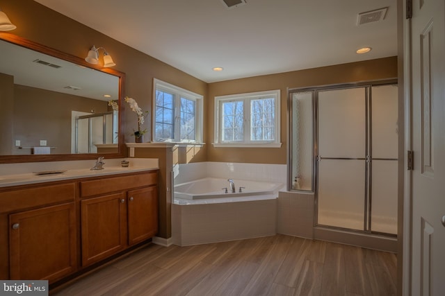 bathroom featuring vanity, separate shower and tub, and wood-type flooring