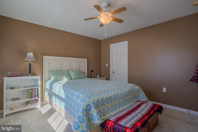 bedroom with light carpet and ceiling fan