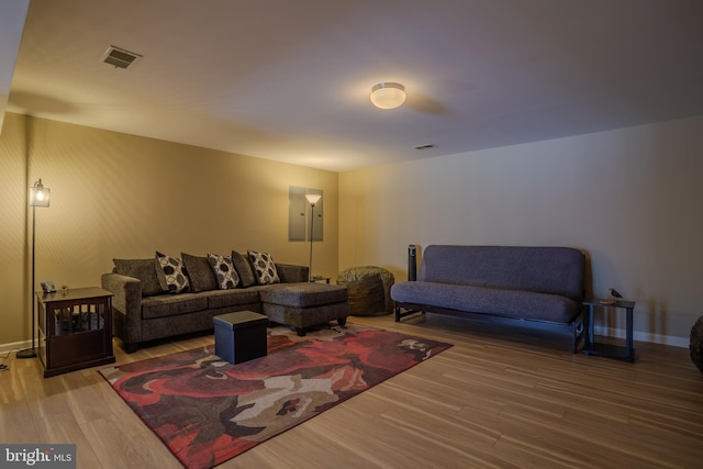 living room with wood-type flooring and electric panel