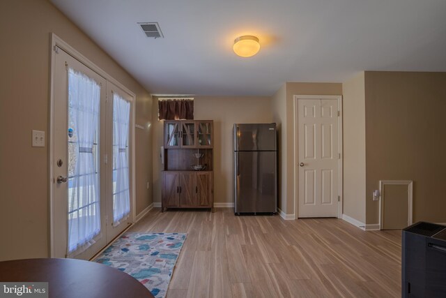 interior space featuring french doors and light wood-type flooring