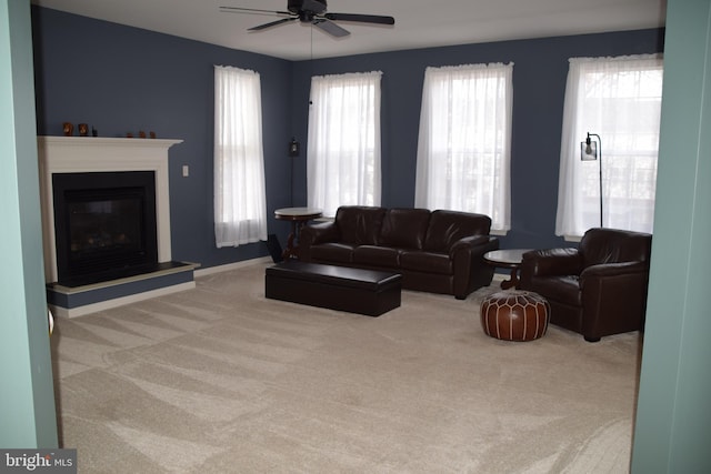 carpeted living room with ceiling fan and a wealth of natural light