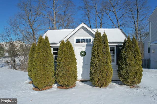 view of snowy exterior with a storage unit