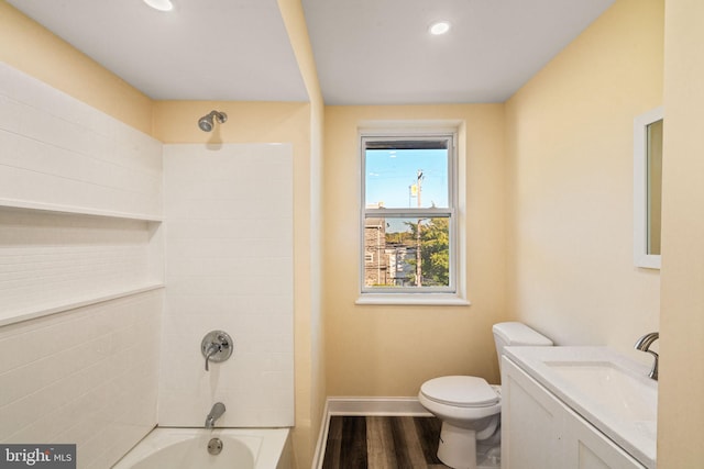 full bathroom with hardwood / wood-style floors, vanity, toilet, and tiled shower / bath