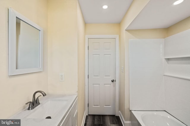 bathroom featuring hardwood / wood-style floors, vanity, and shower / bathtub combination