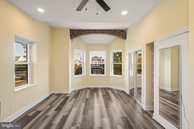 interior space with dark hardwood / wood-style floors and ceiling fan