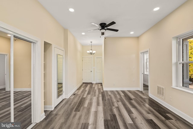 corridor featuring dark hardwood / wood-style flooring and a notable chandelier