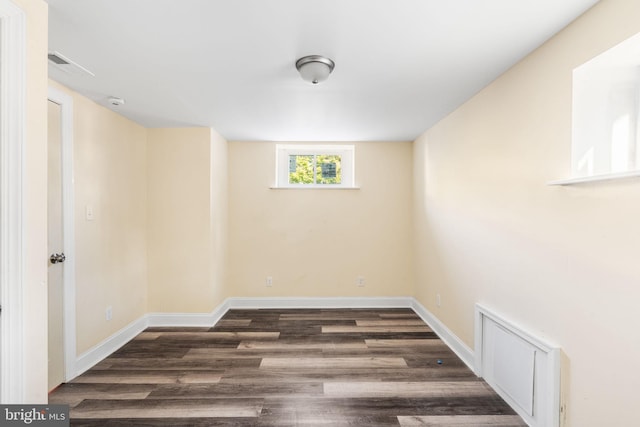 basement featuring dark hardwood / wood-style flooring