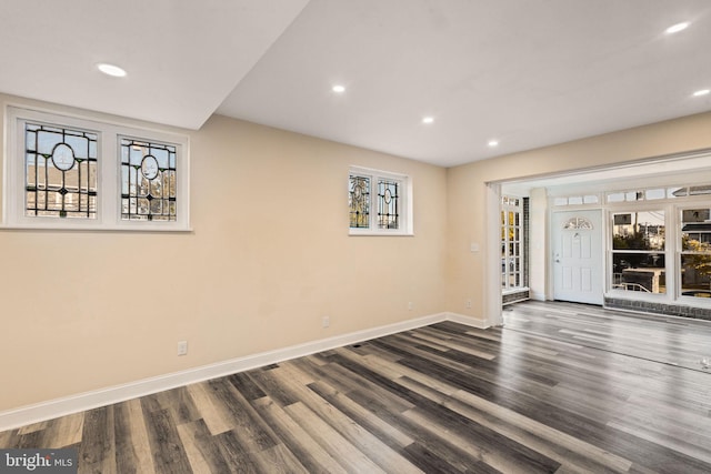 spare room with dark wood-type flooring