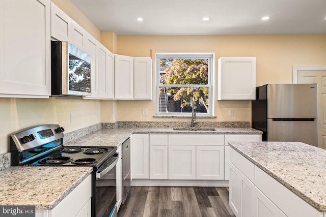 kitchen with white cabinetry, sink, appliances with stainless steel finishes, and dark wood-type flooring