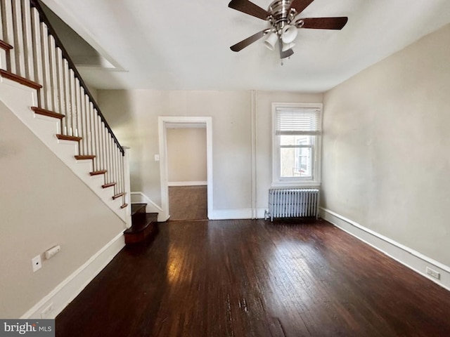 unfurnished living room with radiator heating unit, dark hardwood / wood-style flooring, and ceiling fan