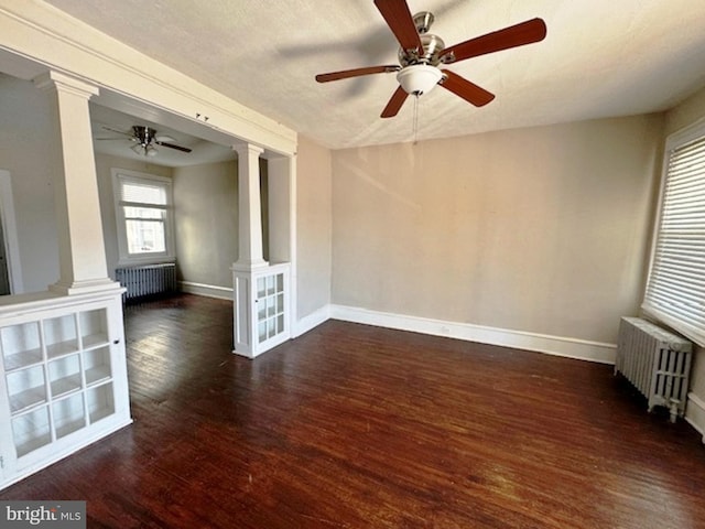 unfurnished living room with radiator, ceiling fan, dark wood-type flooring, and a textured ceiling