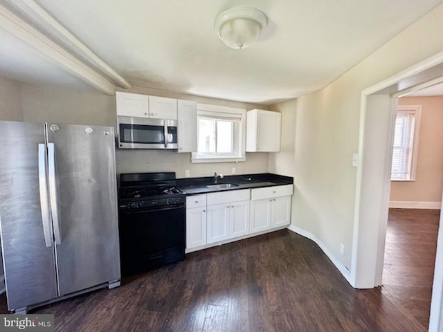 kitchen featuring sink, dark hardwood / wood-style flooring, white cabinets, and appliances with stainless steel finishes