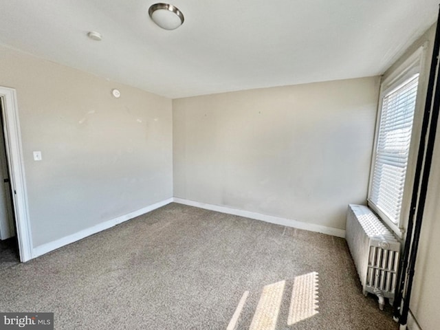 carpeted spare room with radiator