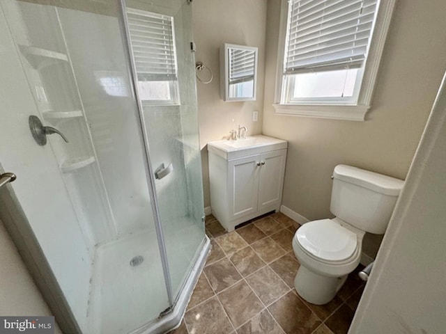 bathroom with a shower with door, vanity, and toilet