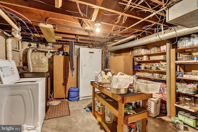 basement with washer / dryer and white refrigerator