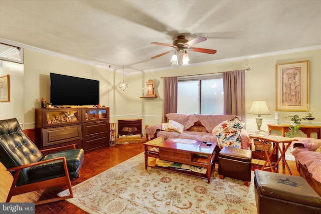 living room featuring hardwood / wood-style flooring, ceiling fan, and ornamental molding