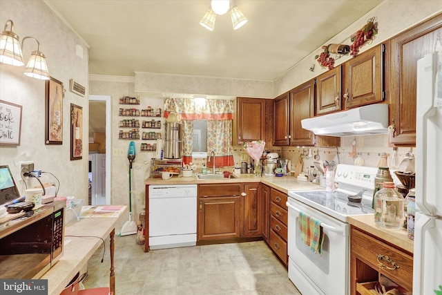 kitchen featuring white appliances and sink