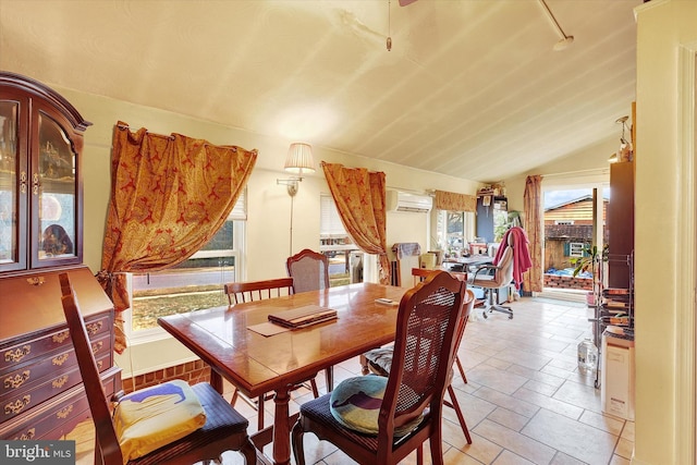 dining space with a wall mounted AC and lofted ceiling