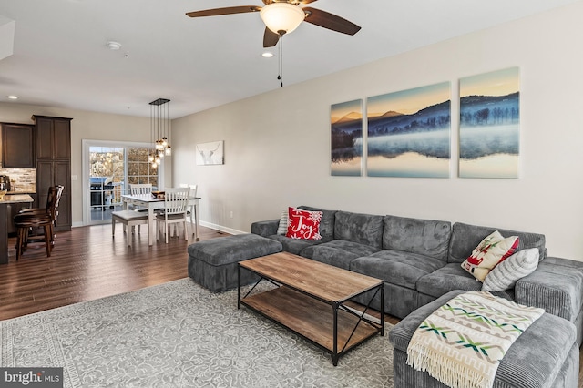 living room with light hardwood / wood-style flooring and ceiling fan