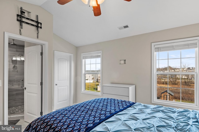 bedroom with ensuite bathroom, ceiling fan, and lofted ceiling