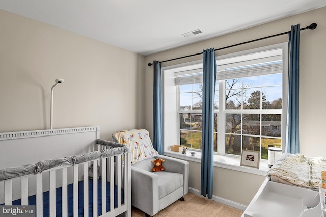 bedroom with carpet flooring and a crib