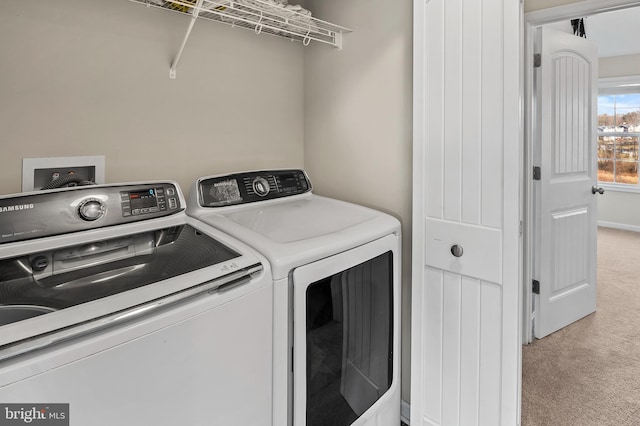 clothes washing area with washing machine and clothes dryer and light carpet