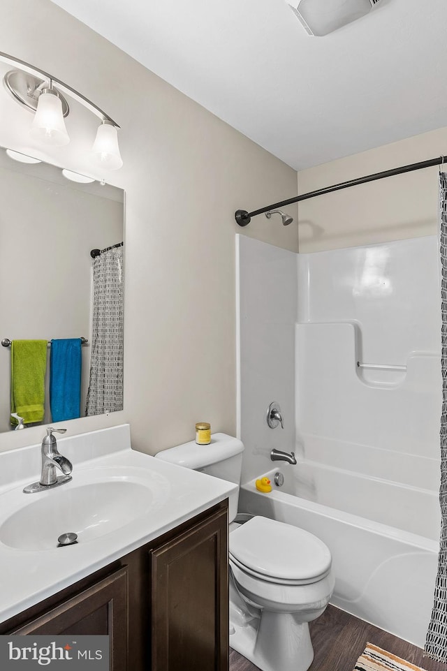 full bathroom featuring hardwood / wood-style flooring, vanity, toilet, and shower / tub combo with curtain