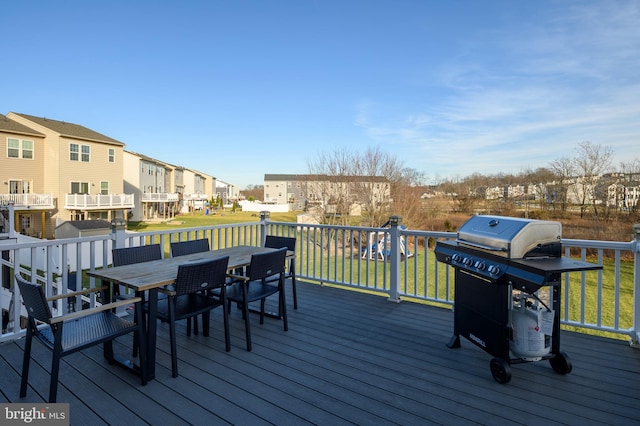 deck with a lawn and grilling area