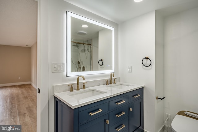 bathroom featuring walk in shower, toilet, vanity, and hardwood / wood-style flooring