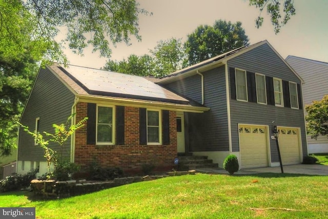 view of front of home featuring solar panels, a yard, and a garage