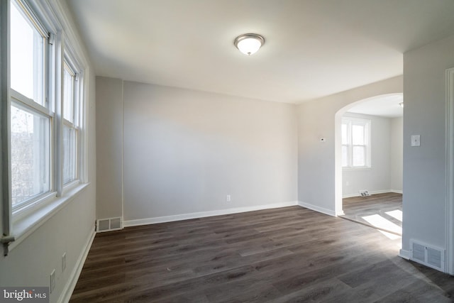 empty room with dark hardwood / wood-style floors