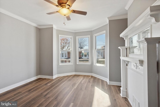 spare room featuring hardwood / wood-style floors, ceiling fan, and ornamental molding