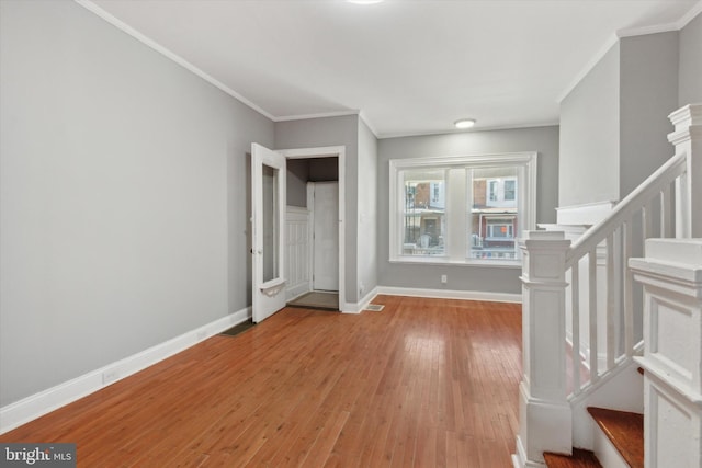 entrance foyer featuring light hardwood / wood-style floors and ornamental molding