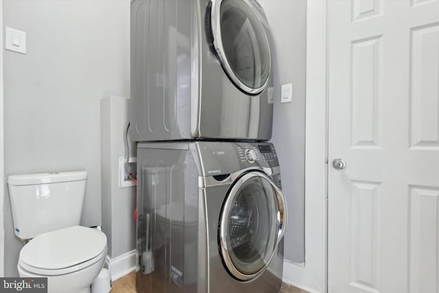 clothes washing area featuring stacked washer and dryer