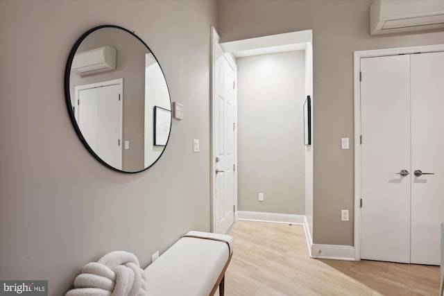 living area featuring light hardwood / wood-style floors and a wall mounted AC