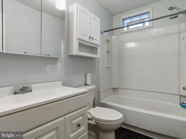 full bathroom featuring vanity, toilet, washtub / shower combination, and a textured ceiling