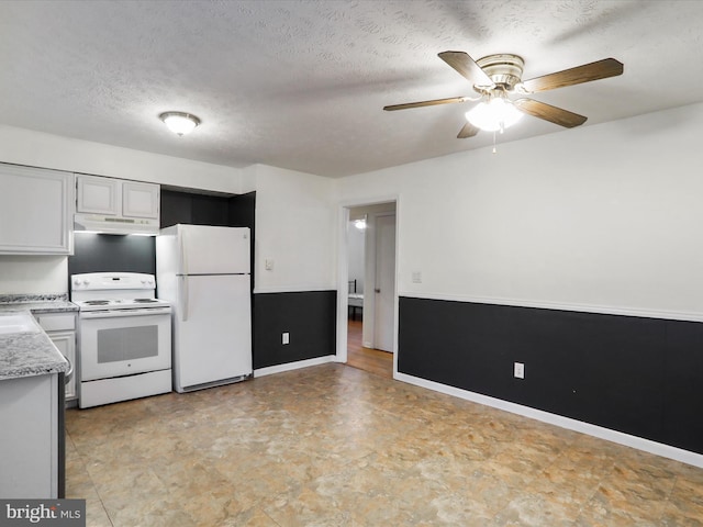 kitchen with a textured ceiling, ceiling fan, white cabinets, and white appliances