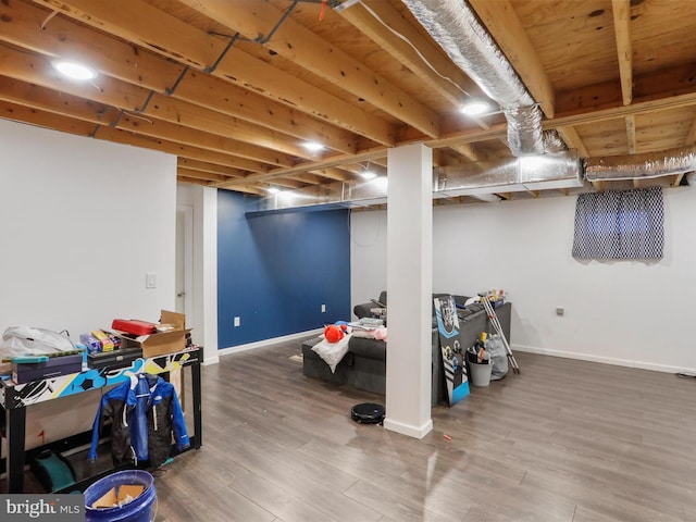 basement with hardwood / wood-style floors