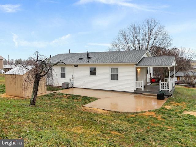 back of property featuring a yard, central AC unit, and a patio area