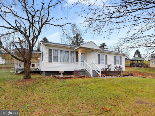 view of front facade with a gazebo and a front lawn