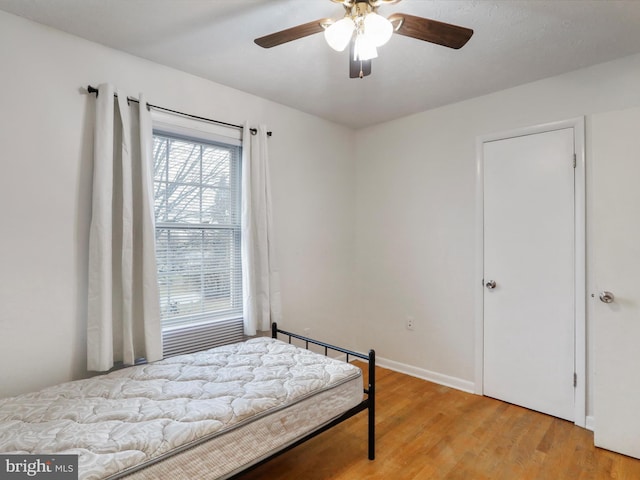 bedroom featuring ceiling fan and light hardwood / wood-style floors