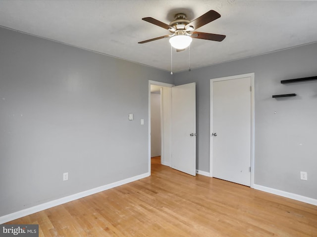 unfurnished bedroom featuring ceiling fan and light hardwood / wood-style flooring