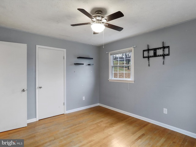 unfurnished bedroom featuring light hardwood / wood-style floors and ceiling fan