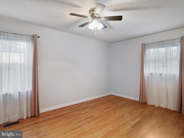 spare room featuring ceiling fan and light hardwood / wood-style flooring