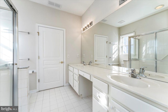 bathroom featuring tile patterned flooring, vanity, and walk in shower