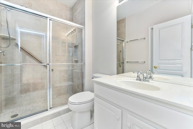 bathroom with tile patterned floors, a shower with shower door, and toilet