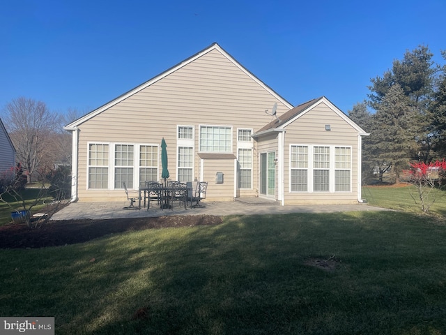 back of property featuring a lawn and a patio area