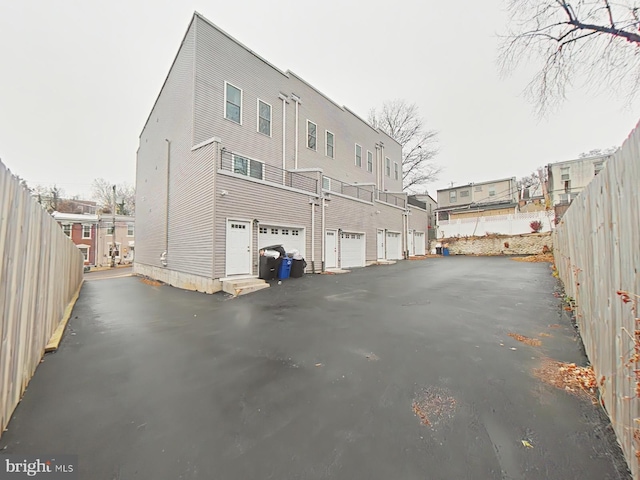 rear view of house with a garage